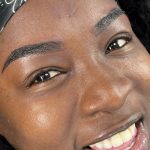 Closeup of a black female client after her regular touch-up.
