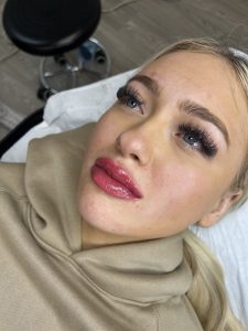 A female client's profile after having her lips tattooed.