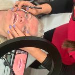 A mature client lying down for Lip Blushing treatment.