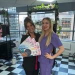 A female student with Cara showing off all her certificates from her Cosmetic Training Courses.