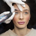 A young woman having eyebrow enhancement from a student making a transition from Microblading to Machine.